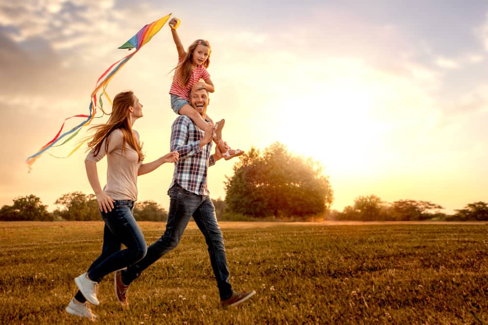 happy family running in a field
